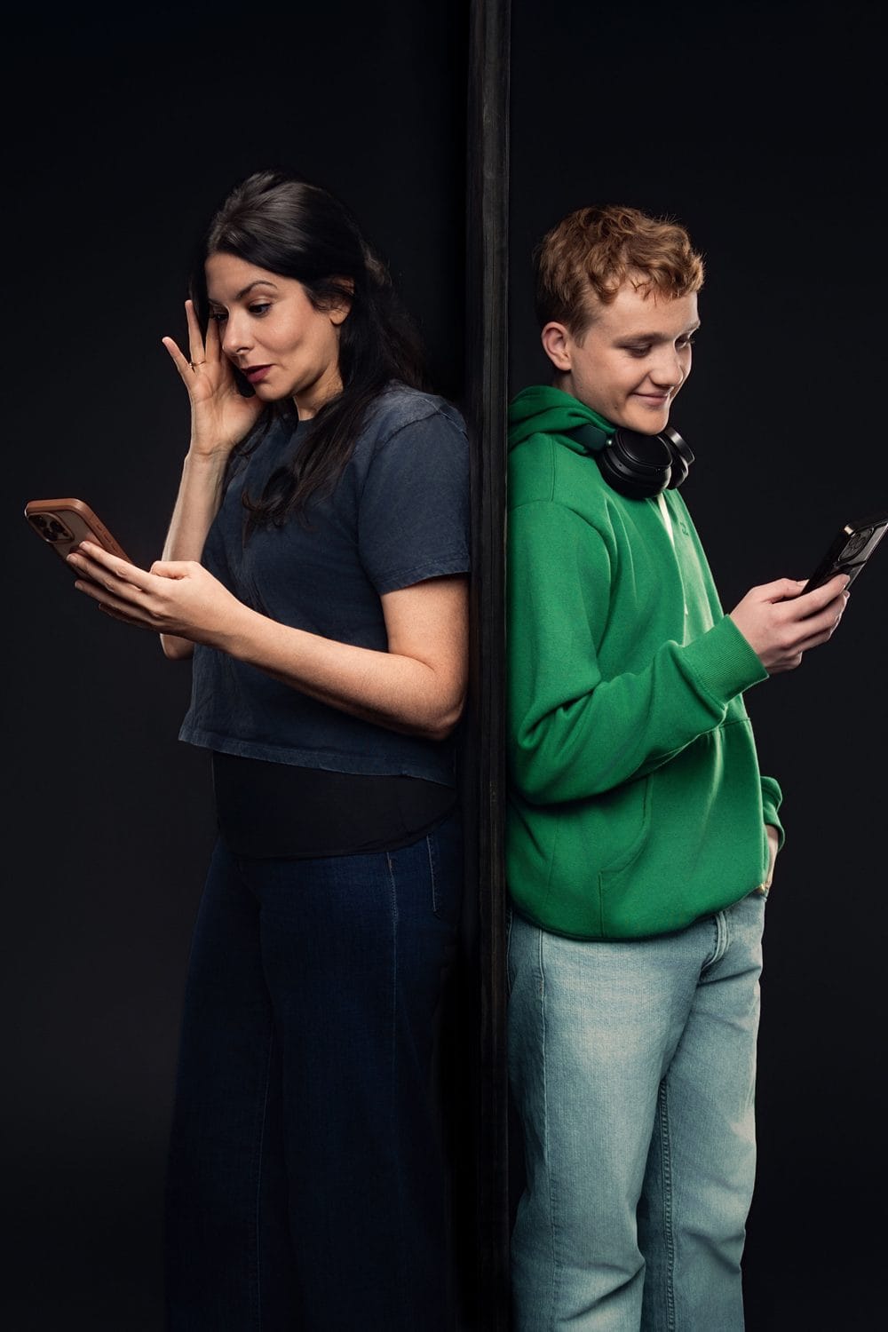 Tammy and her son Cody, each looking at a phone, in It's All Her Fault